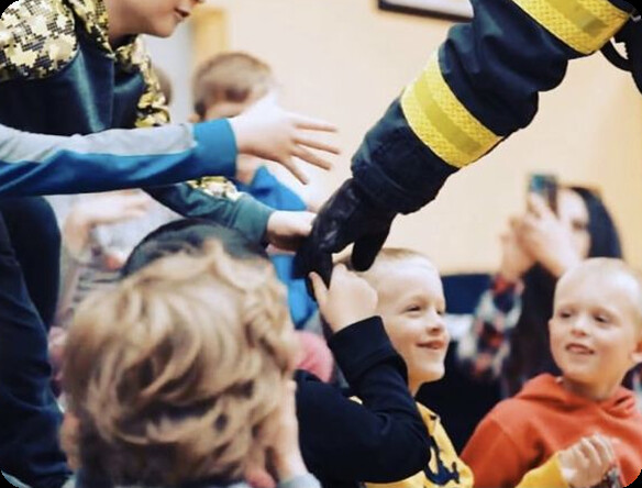 Firefighter demonstrating safety to children